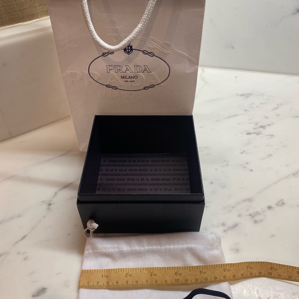 White Prada shopping bag with black jewelry case and more